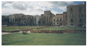 Apse of Magione viewed across part of park.