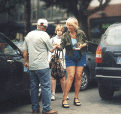 Car parker accepts payment from German motorist in Palermo's Piazza Castelnuovo.